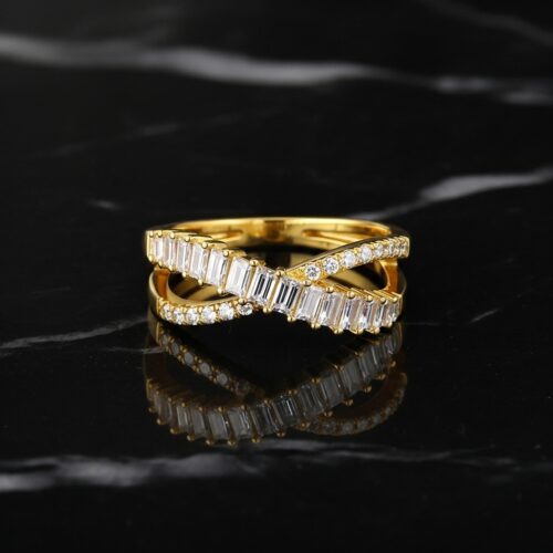 StudioShot Eternal Cross Diamond Ring in gold – close-up studio view of timeless crossover design with baguette and round lab-created diamonds on black marble