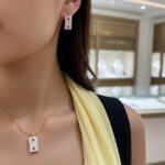 Woman wearing Ruby Accent Rectangle Pendant Set showing the sparkling pendant with ruby accents and matching earring