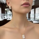 Close-up of woman wearing Sparkling Rectangle Pendant Set highlighting the sparkling rectangular pendant and matching earring