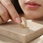 Hand holding Double Row Brilliance Adjustable Ring showing the sparkling round stones and comfortable adjustable open style