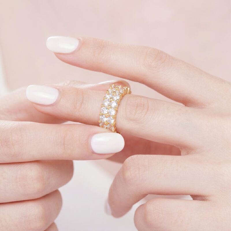 Close view of hand putting on the Double Row Brilliance Adjustable Ring showing detailed two rows of brilliant stones