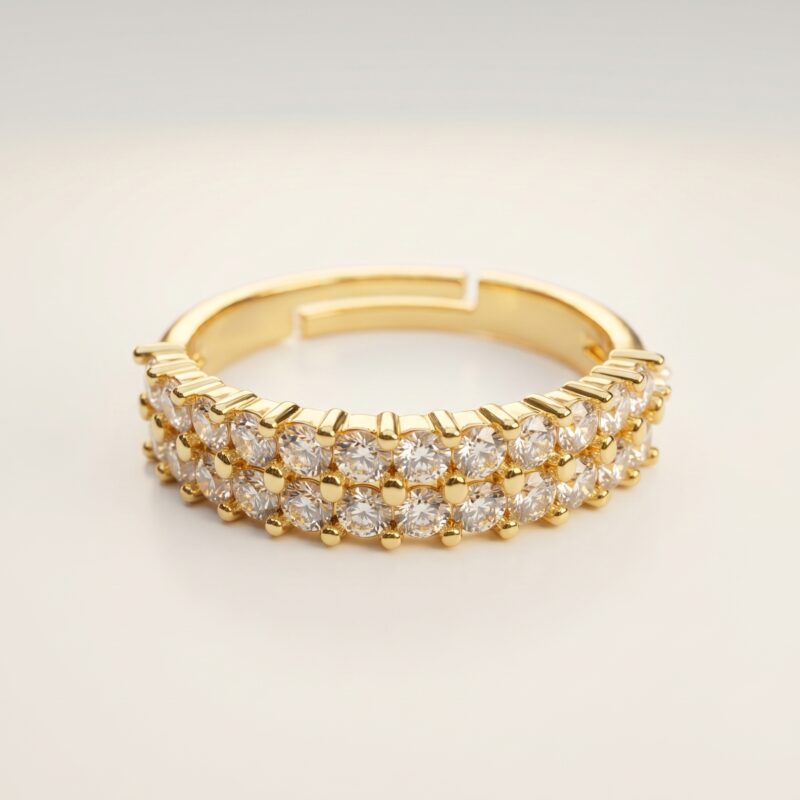 Studio shot of Double Row Brilliance Adjustable Ring on clean background showing two full rows of sparkling round stones and warm gold finish