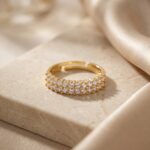 Double Row Brilliance Adjustable Ring displayed on marble and silk background highlighting the double row sparkle and open adjustable design